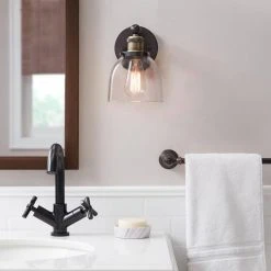 Home Decorators Collection Evelyn 6 in. 1-Light Bronze Modern Industrial Wall Mount Sconce Light with Clear Glass Shade 14 Home Decorators Collection Evelyn 6 in. 1-Light Bronze Modern Industrial Wall Mount Sconce Light with Clear Glass Shade -Flora Home Decorators Soldes artisan bronze home decorators collection vanity lighting hb15018 313 e1 1000